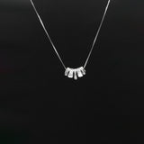 Silver necklace with a unique pendant on a black background