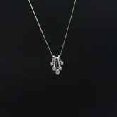 Silver necklace with a pendant on a black background