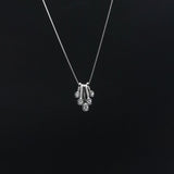 Silver necklace with a pendant on a black background