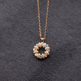 Necklace with a circular pendant featuring multicolored stones on a dark textured background