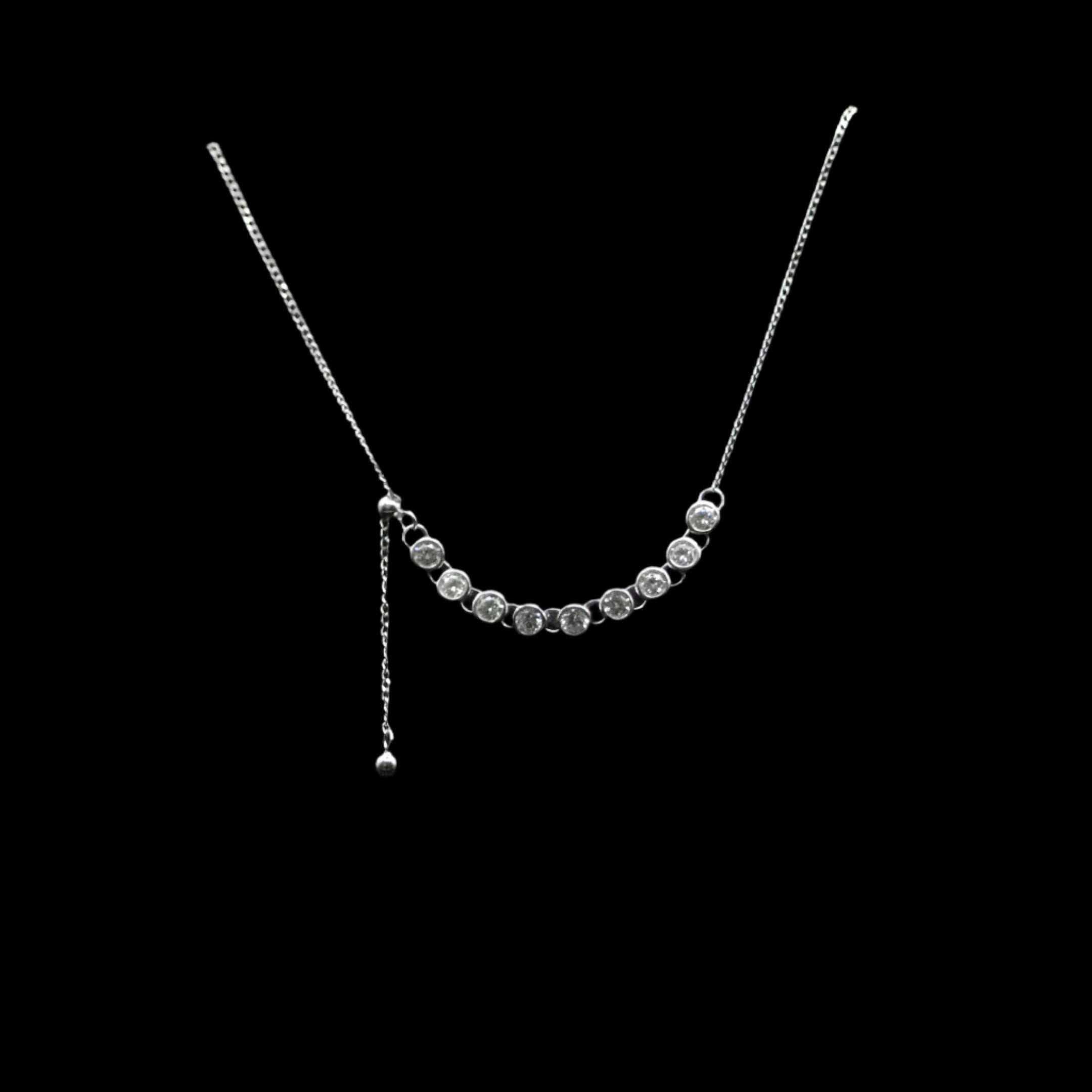 Silver necklace with small beads on a black circular stand