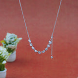 Silver necklace with beads on a red background