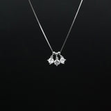 Silver necklace with a pendant on a black background
