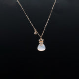 Necklace with a blue teardrop pendant on a black background