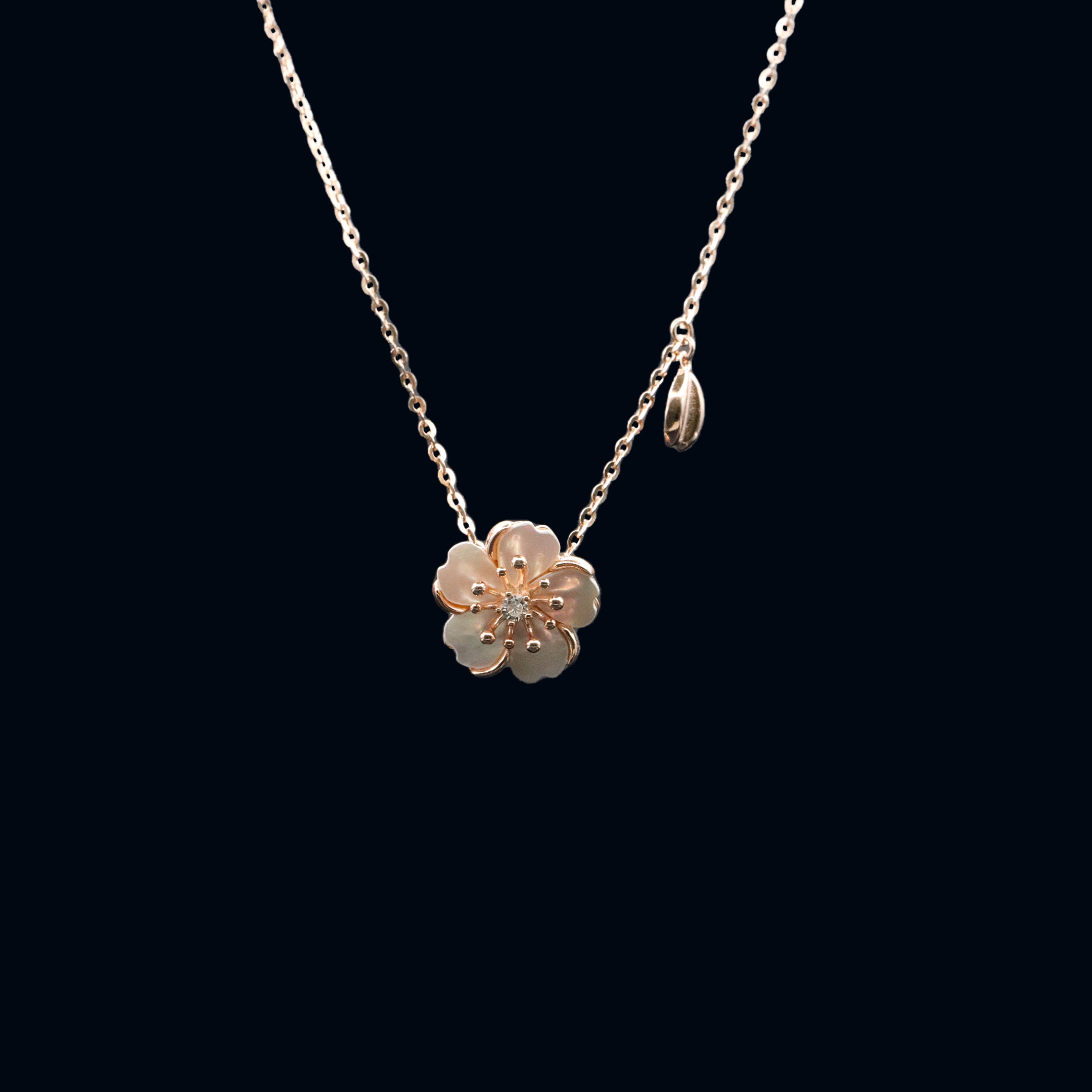 Gold flower-shaped necklace on a black background
