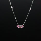 Necklace with a pink pendant on a black background