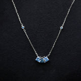 Necklace with a blue pendant on a black background