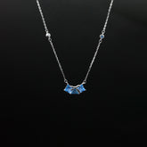 Necklace with a blue pendant on a black background