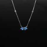 Necklace with a blue pendant on a black background