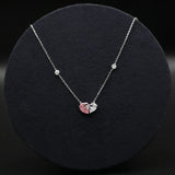 Necklace with a heart-shaped pendant on a black background