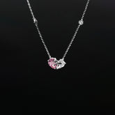 Necklace with a pink heart-shaped pendant on a black background