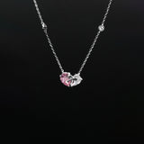 Necklace with a pink heart-shaped pendant on a black background