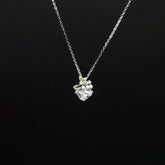 Silver necklace with a floral pendant on a black background