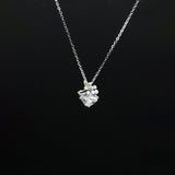 Silver necklace with a floral pendant on a black background