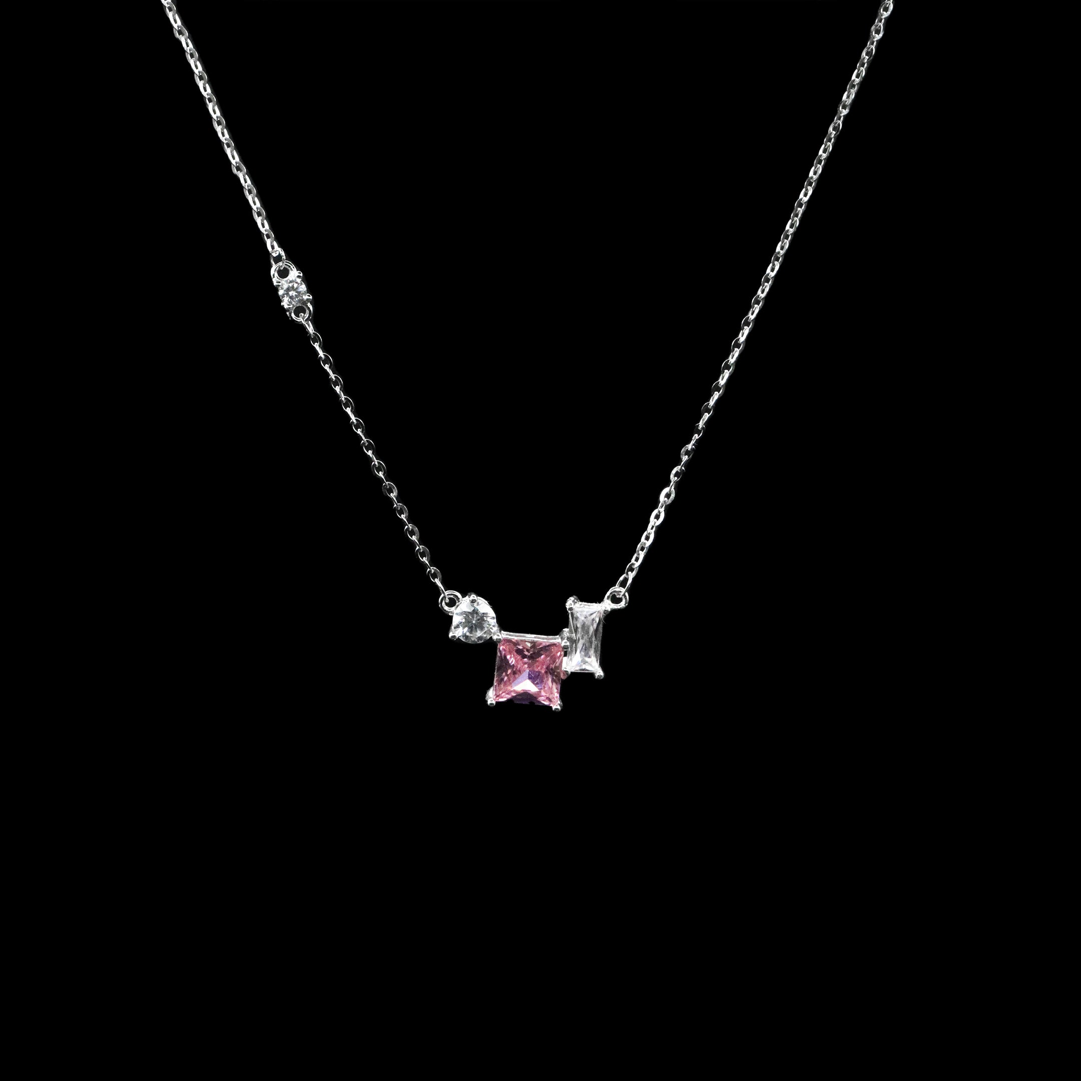 Necklace with a pink gemstone and silver accents on a black background