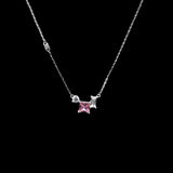 Necklace with a pink gemstone and silver accents on a black background