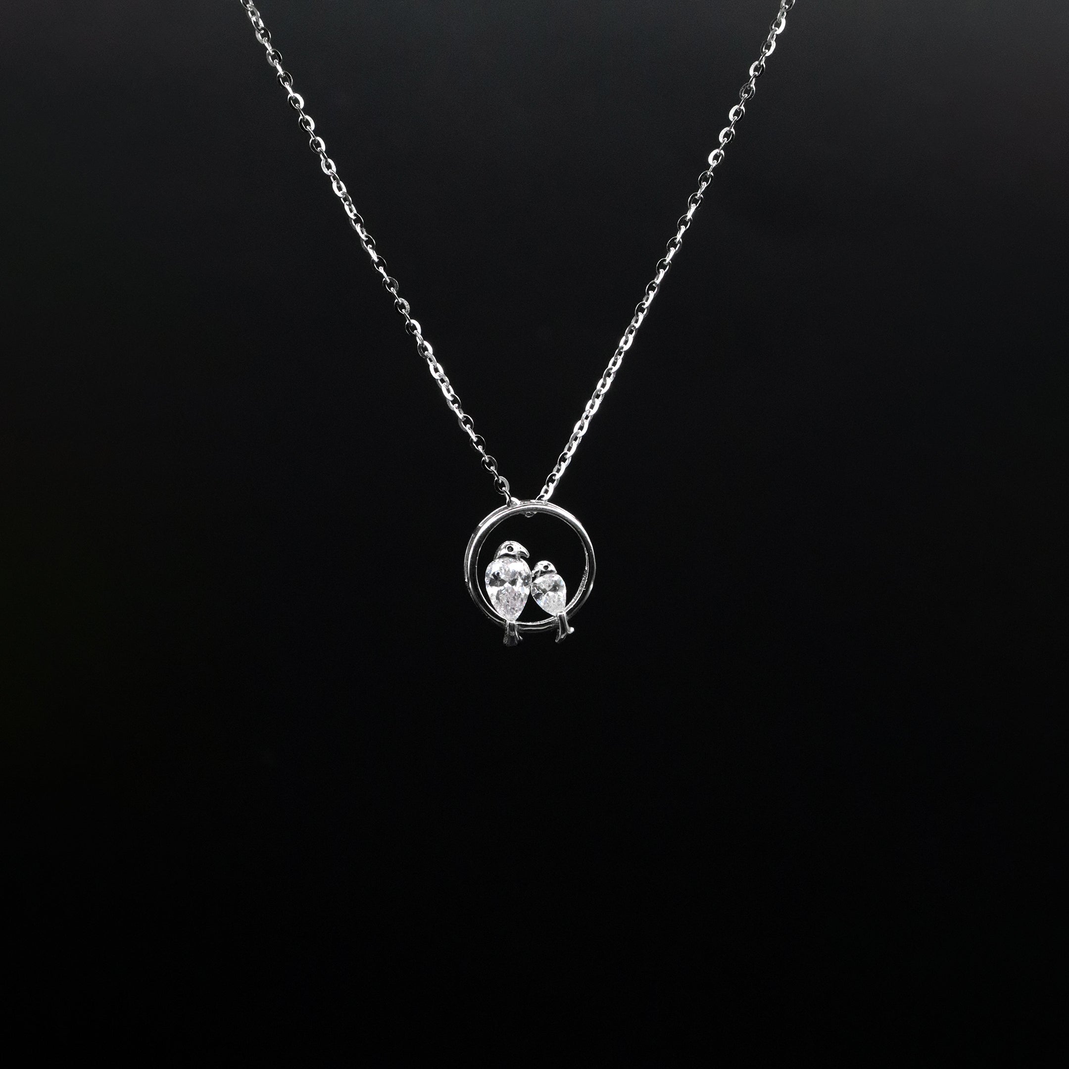 Silver necklace with a pendant on a black background