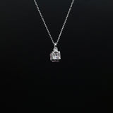 Silver necklace with a square pendant on a black background