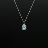 Necklace with a pendant featuring a blue gemstone on a black background