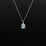 Necklace with a pendant featuring a blue gemstone on a black background