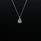 Silver necklace with a square pendant on a black background