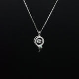 Silver snake-shaped pendant necklace on a black background