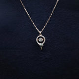 Necklace with a circular pendant on a dark textured background