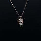 Necklace with a decorative pendant on a black background