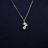 Necklace with teardrop-shaped pendant on a dark blue background