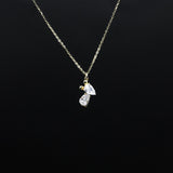 Gold necklace with a diamond pendant on a black background