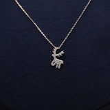 Silver reindeer pendant necklace on a dark blue background