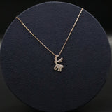 Necklace with a reindeer pendant on a dark blue cushion
