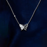 Silver butterfly necklace on a dark blue background