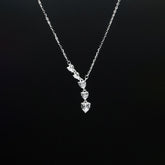 Silver necklace with a pendant on a black background