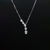 Silver necklace with a pendant on a black background