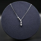 Silver necklace with a pendant on a dark blue cushion