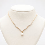 Pearl necklace on a mannequin bust with a white background