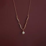 Necklace with a pearl pendant on a dark red background