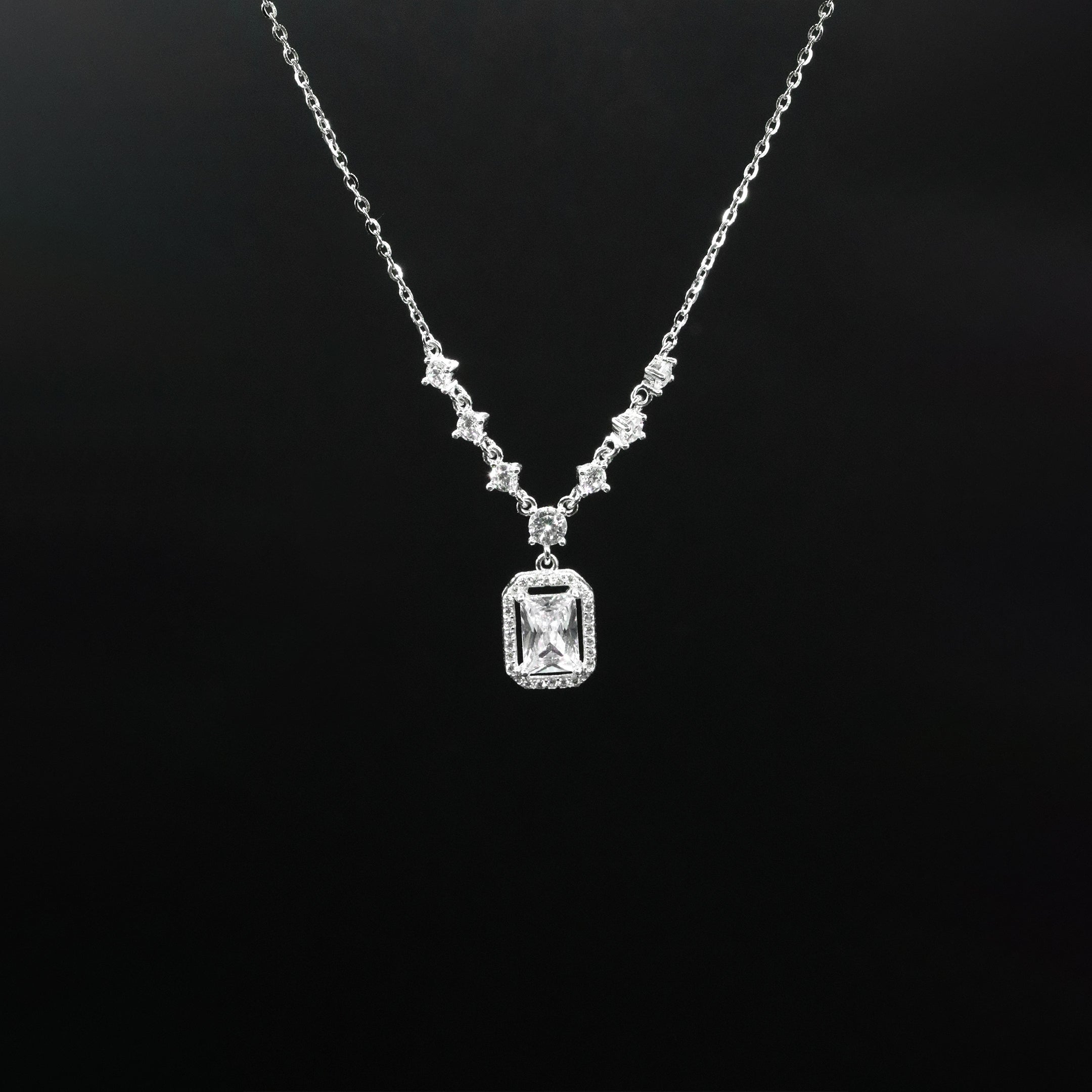 Diamond necklace with a rectangular pendant on a black background