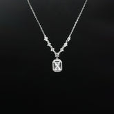 Diamond necklace with a rectangular pendant on a black background