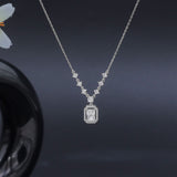Diamond necklace on a dark background with a blurred car wheel in the corner