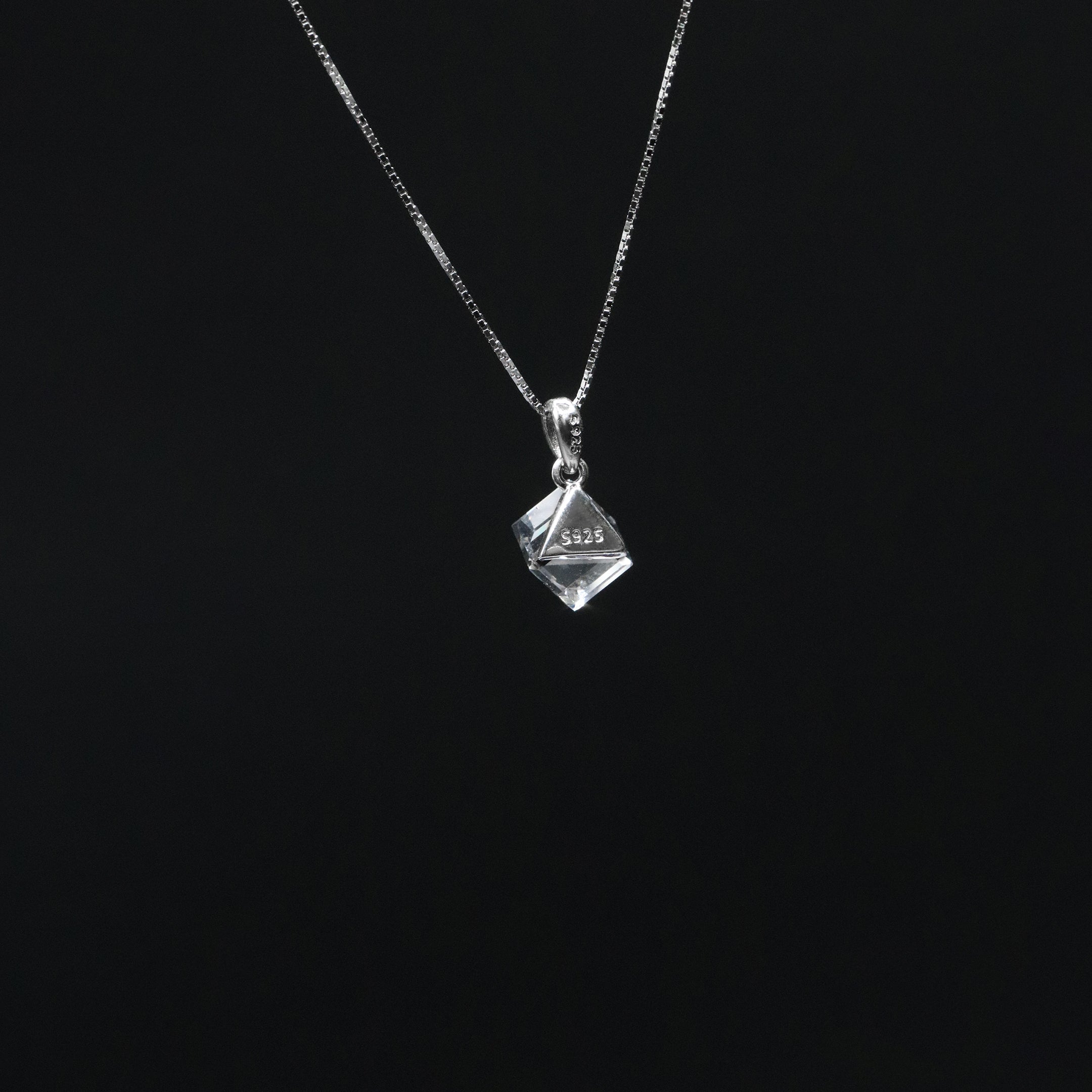 Crystal pendant necklace on a black background