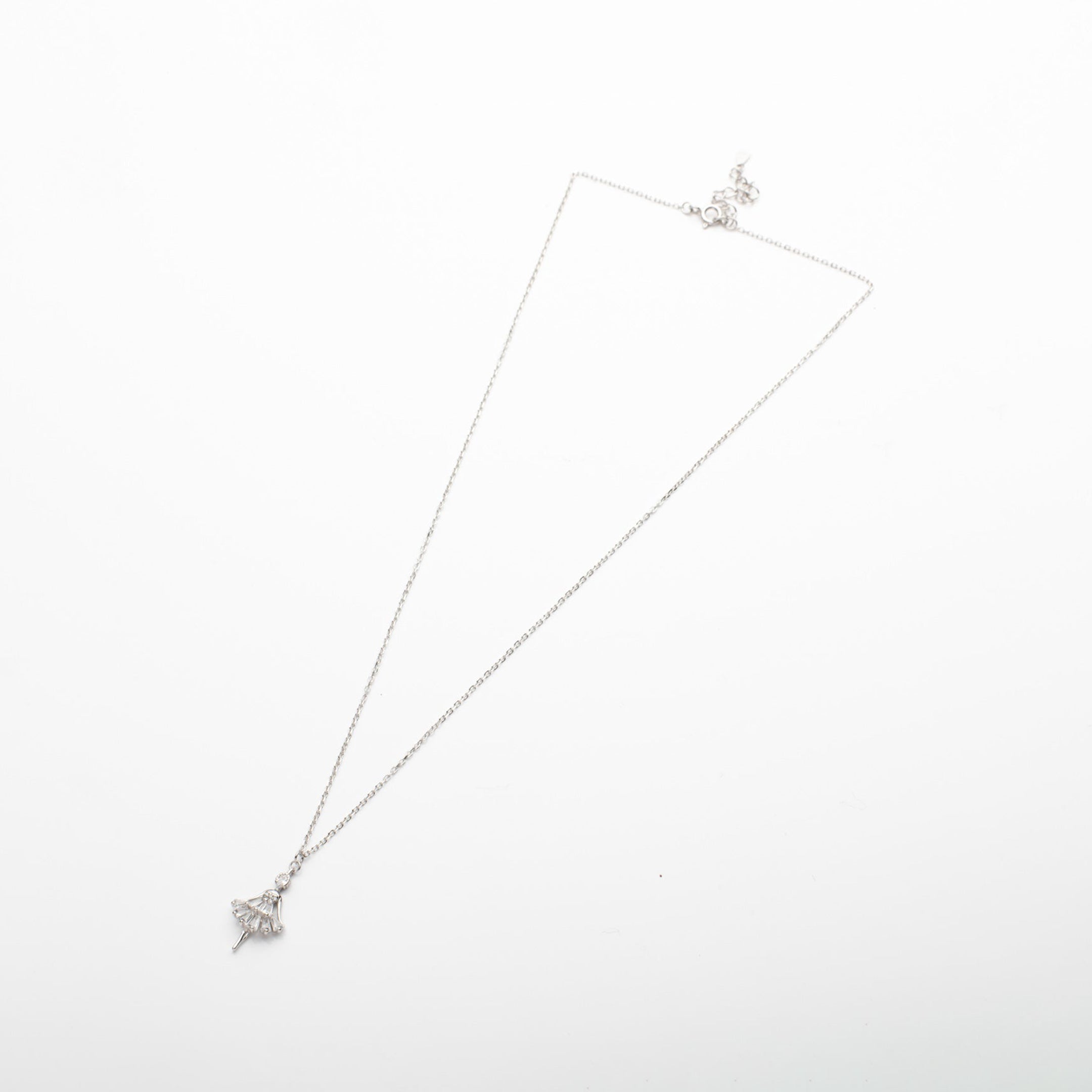 Silver necklace with a star-shaped pendant on a white background