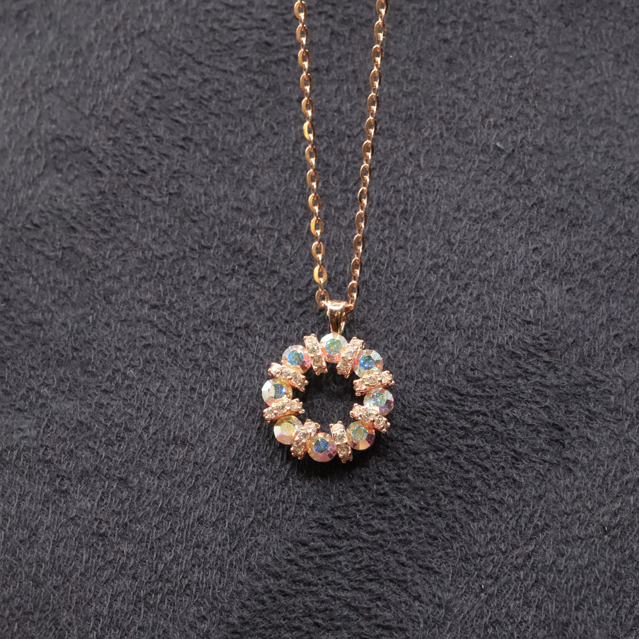 Necklace with a circular pendant featuring multicolored stones on a dark textured background