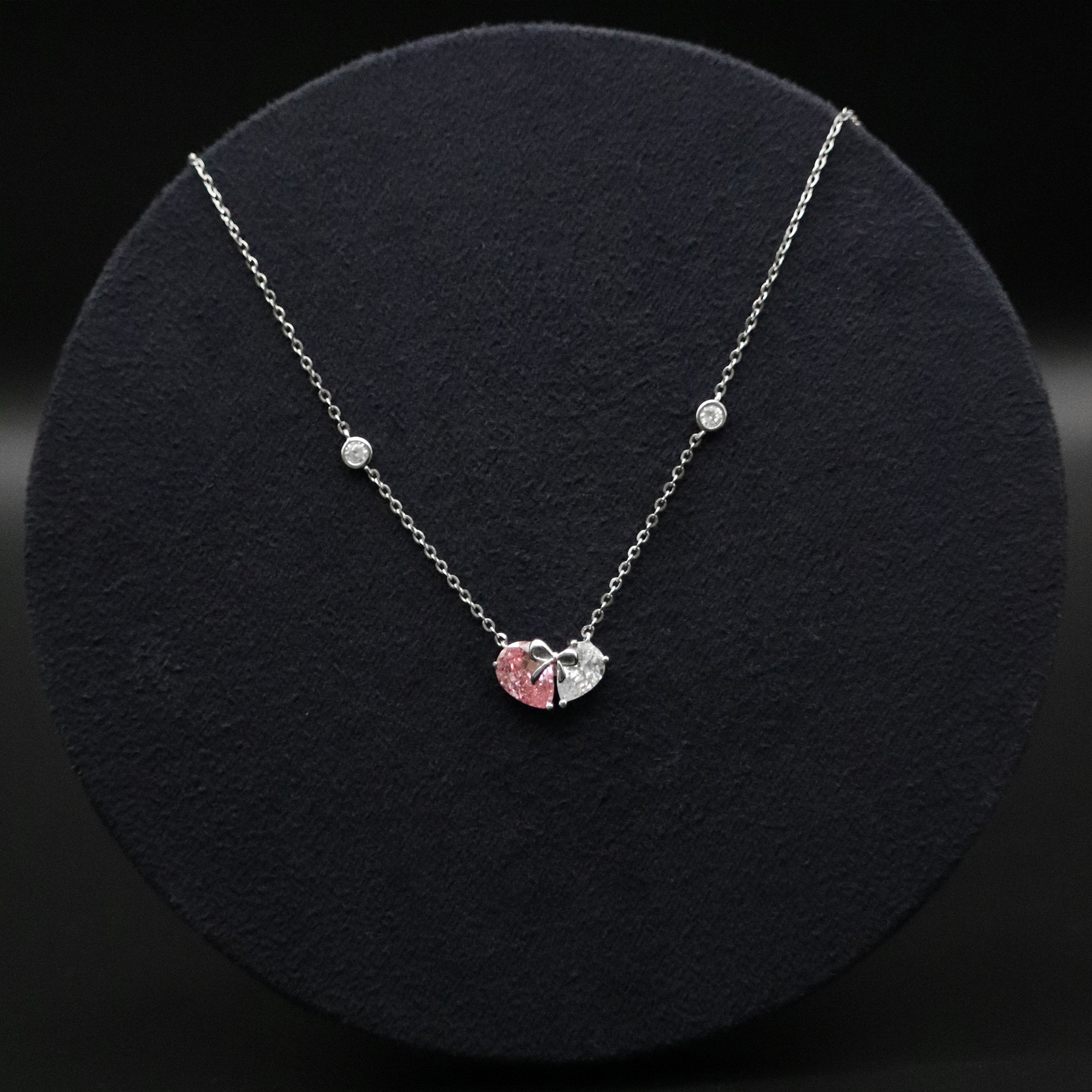 Necklace with a heart-shaped pendant on a black background