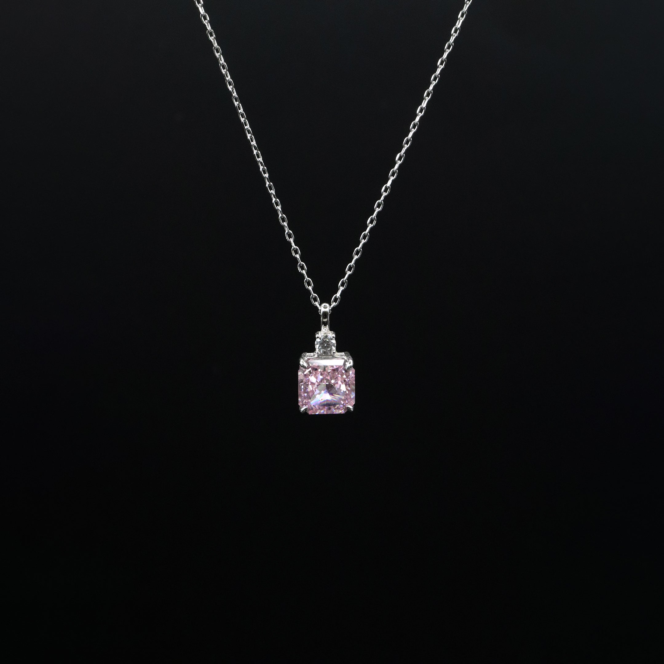 Pink square pendant necklace on a black background