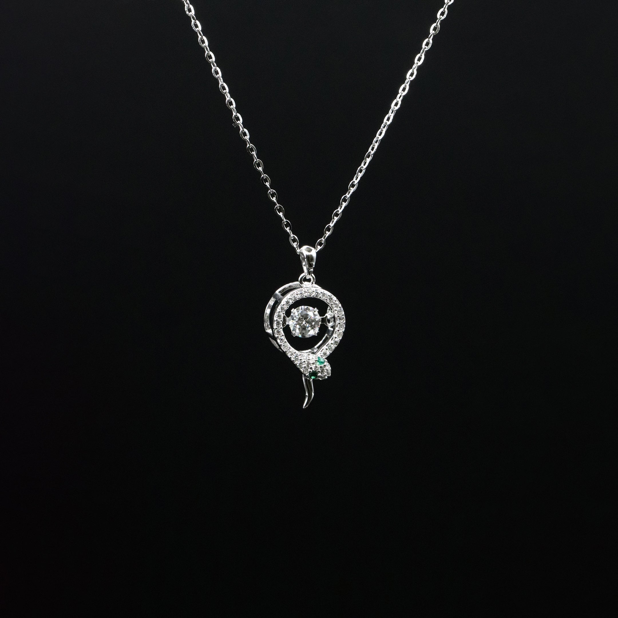 Silver snake-shaped pendant necklace on a black background