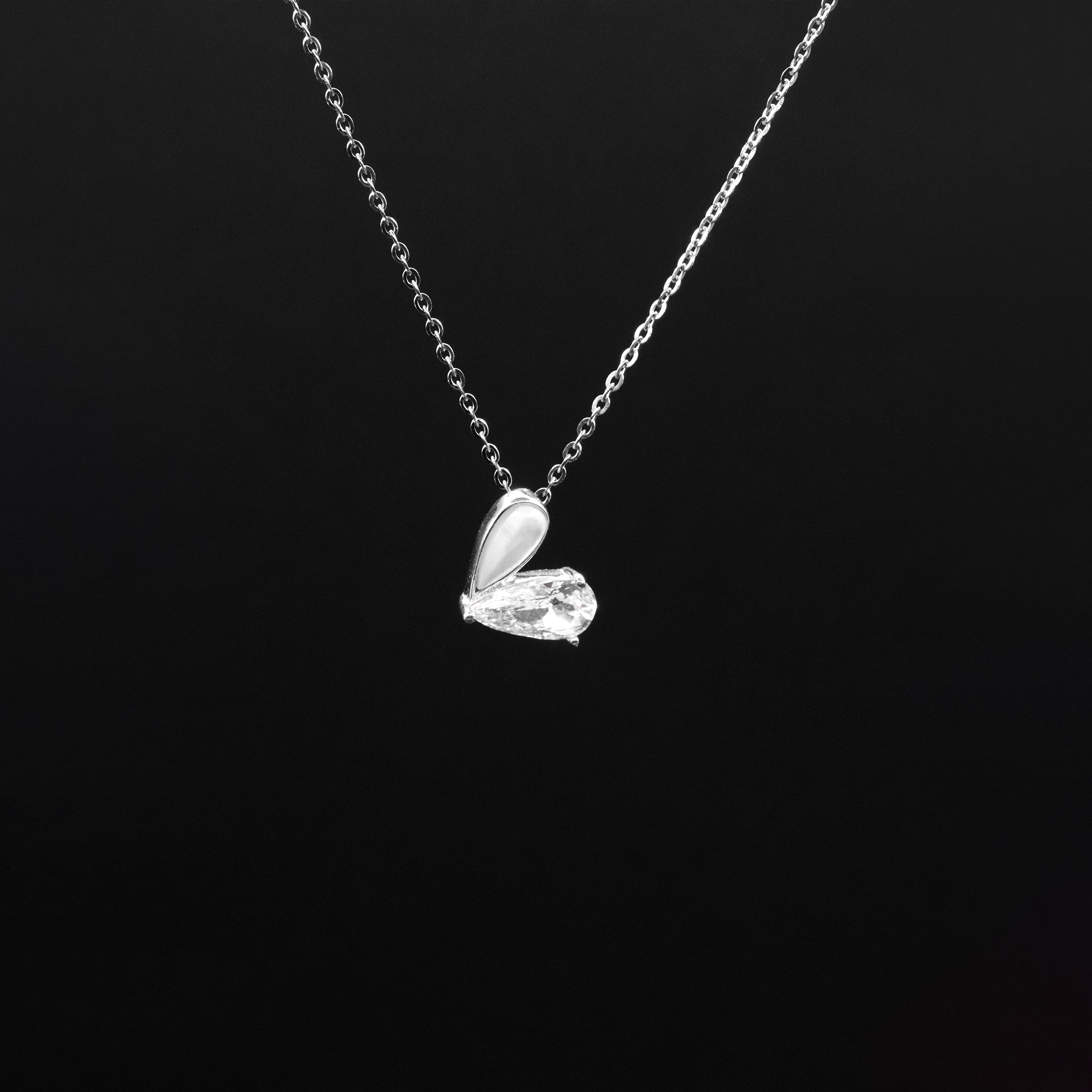 Silver necklace with a unique pendant on a black background