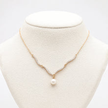 Pearl necklace on a mannequin bust with a white background