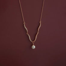 Necklace with a pearl pendant on a dark red background